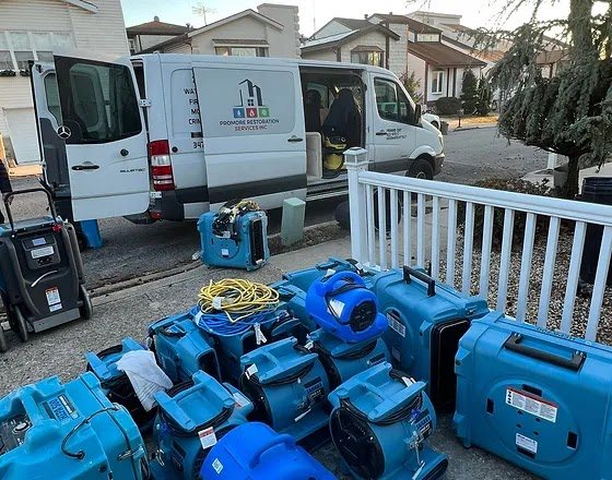 Restoration van and drying equipment at a Tucson job site